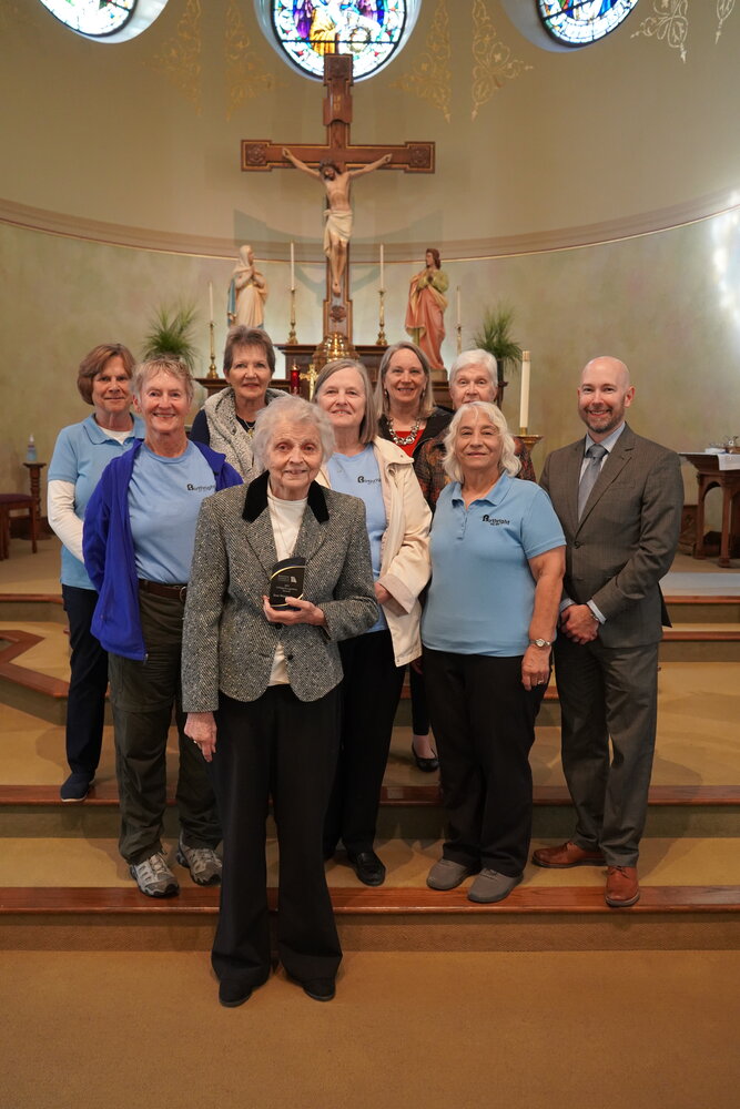 A group of volunteers joins Jean Wankum in the sanctuary of Immaculate Conception Church in Jefferson City.
